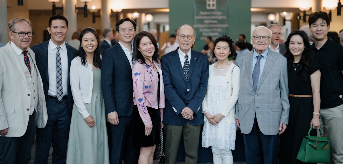 Bruce Waltke poses with the Chee family in Regent's atrium